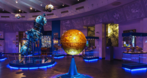 ASTC 2024 Annual Conference View of a science museum exhibition featuring a globe, and space-related displays.