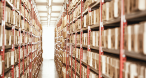 ARCHIVES * RECORDS 2024 A long hallway lined with shelves and shelves of archived boxes.