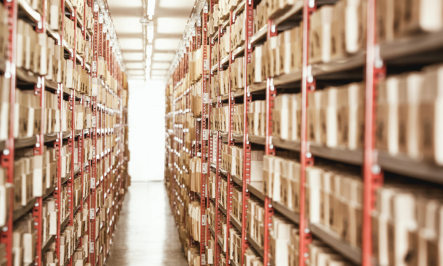 A long hallway lined with shelves and shelves of archived boxes.