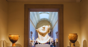 Sustainability & Museum Exhibit Design: 8 Best Practices View of a museum gallery centered on a damaged marble bust, missing everything above the nose.