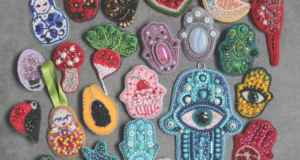 Unlocking Current Trends in Museum Shops A collection of handmade beaded brooches on a table.
