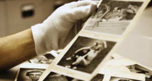 Digitizing Collections: The Benefits You May Not Have Considered Hands in white gloves holding black and white archival photos
