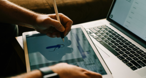 October 7 | Webinar: How to Create Accessible and Engaging Flyers and Content View of someone drawing on a tablet with a laptop in the background