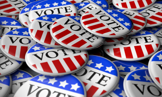 Pile of U.S. election pins that say "VOTE"