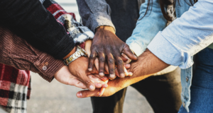 October 30 | 3-Part Virtual Workshop: Community-Centered Engagement Diverse group of people stacking hands in a show of community