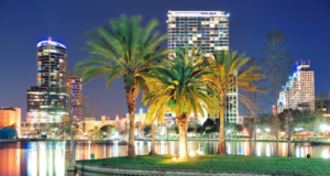 November 18 – 22 | IAAPA Expo 2024 Orlando skyline at night with palm trees and water