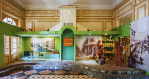 The Future of Traveling Exhibitions: A New Opportunity for Your Museum A museum with green walls and a tiled floor