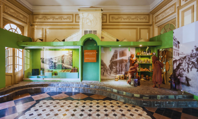 A museum with green walls and a tiled floor