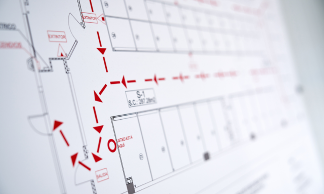 Close up of an evacuation map with red arrows on it