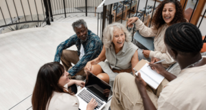 Engaging Older Adults: Successful Museum Programs That Combat Social Isolation and Ageism Diverse group of people sitting on stairs having a meeting