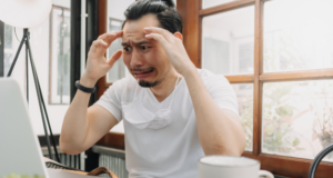 Authentic Leadership: Breaking the Cycle of Museum Politics Man looking at laptop with a stressed on expression on his face