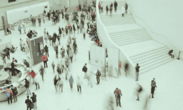 birds-eye view of many visitors in a museum