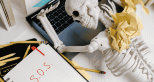 Potential Balms for an Overstretched Museum Workforce toy skeleton at a laptop, symbolizing burnout