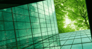 May 13 – 14 | Virtual Conference: greenloop 25 the view from inside a green glass building looking up at green trees