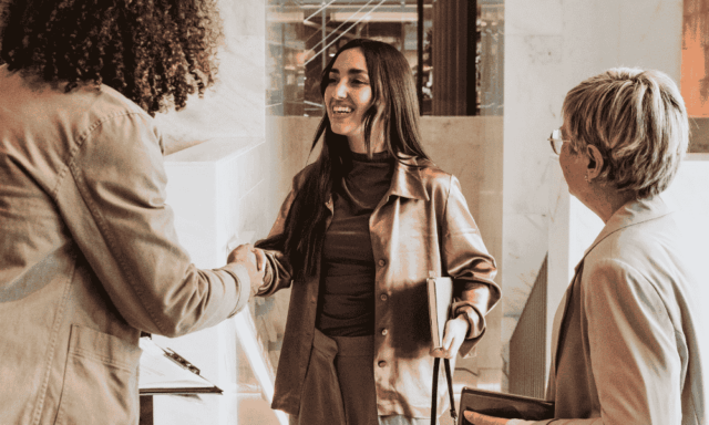 Co-workers smiling and shaking hands