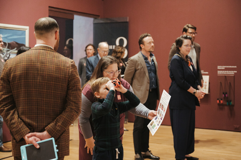Child using binoculars at OKCMOA From the Vault exhibition