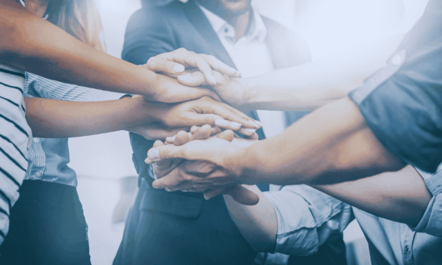 people stacking hands, indicating community