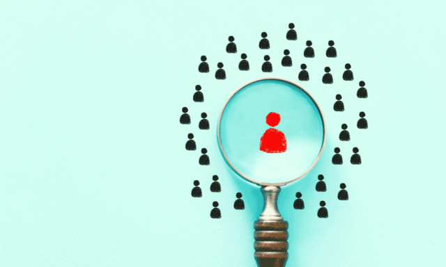 a magnifying glass spotlighting a person icon in the middle of a group of similar icons