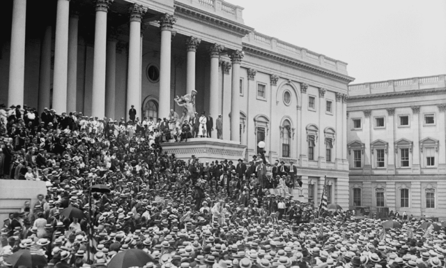 Old black and white photo of a huge crowd of people gathered at the U.S. Capitol