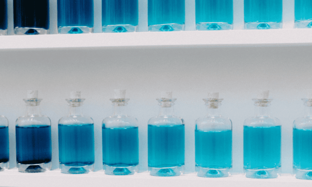 shelves with glass bottles of blue liquid in varying shades of blue