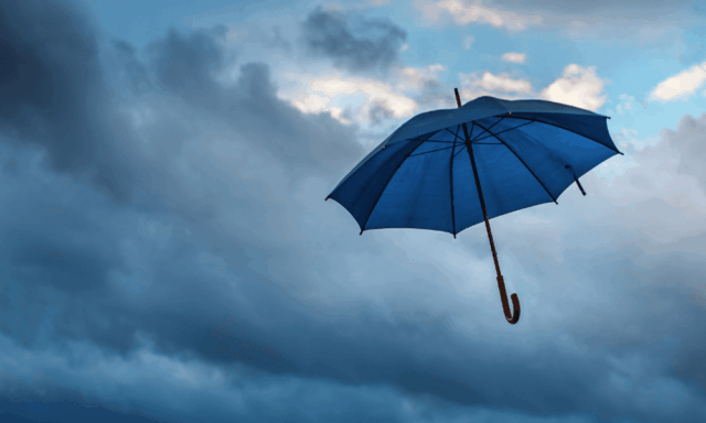 an umbrella against a cloudy sky
