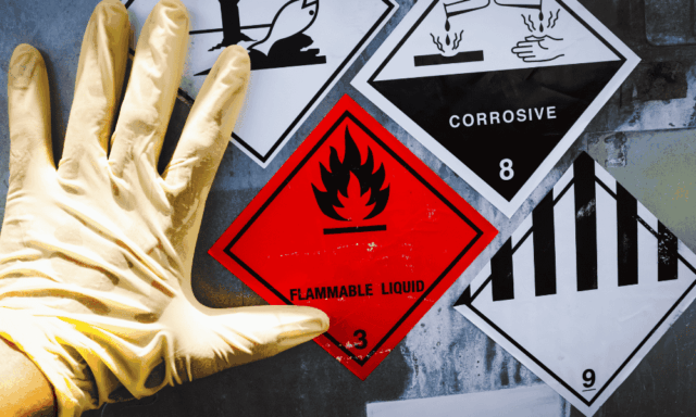 A gloved hand next to warning symbols for hazards
