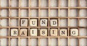 5 Museum Fundraising Success Stories and Inspiration Wood blocks spelling out Fundraising on a wooden shelf