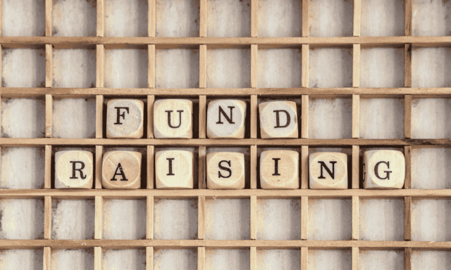 Wood blocks spelling out Fundraising on a wooden shelf