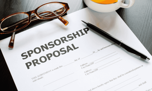 a blank sponsorship proposal on a table with a pen and reading glasses