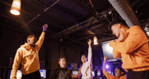 October 9 | Trivia Isn’t Trivial 2.0 group of guys celebrating/cheering