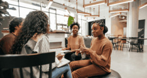 October 28 | Co-Creating With Communities: Inspiring Partner Stories 4 people sitting together for a casual meeting