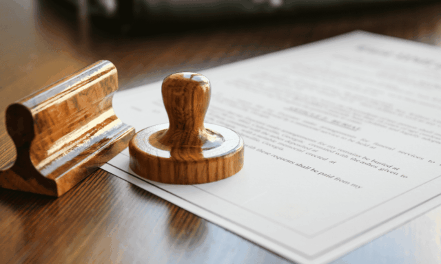 An ink stamper atop a document