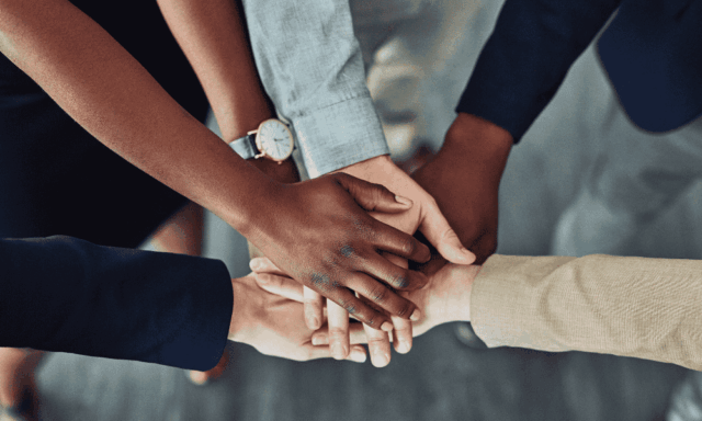 Stacked hands to show teamwork