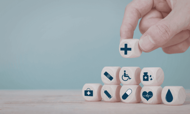 stack of tiny wooden blocks stamped with healthcare icons